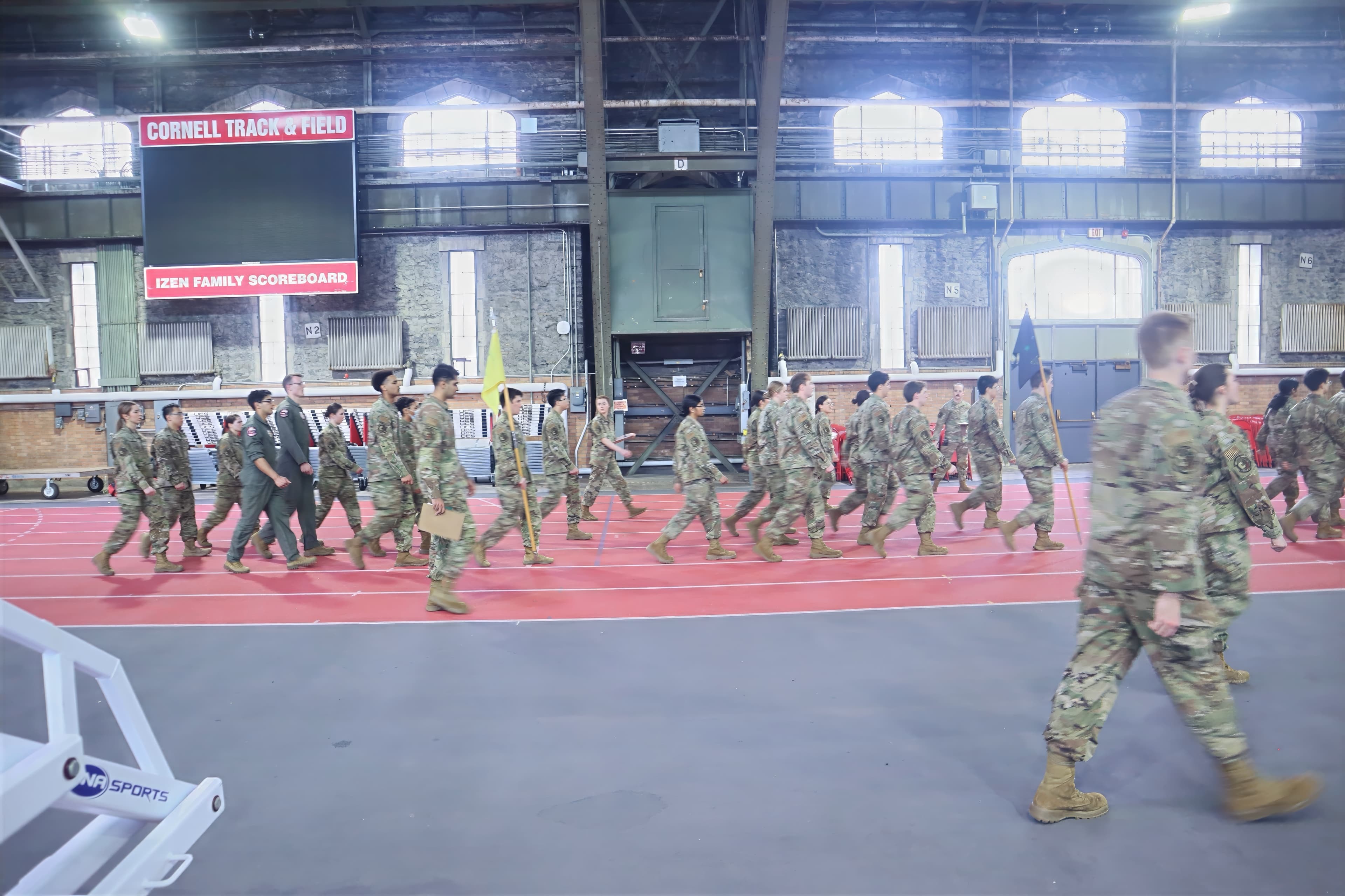 Guidon bearers move their flags into position during a formation in Barton Hall.